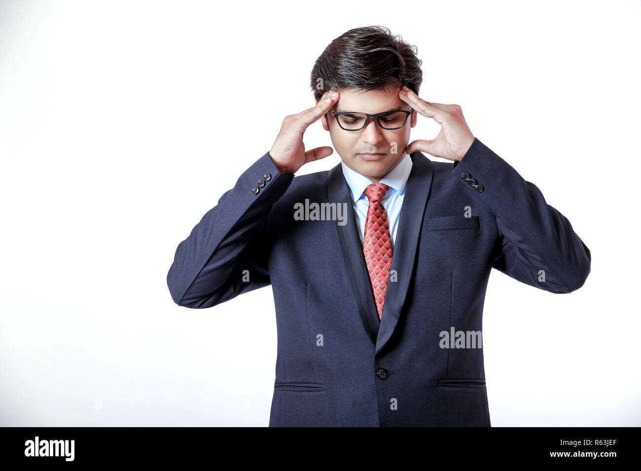 Young indian businessman with headache over white background Stock Photo