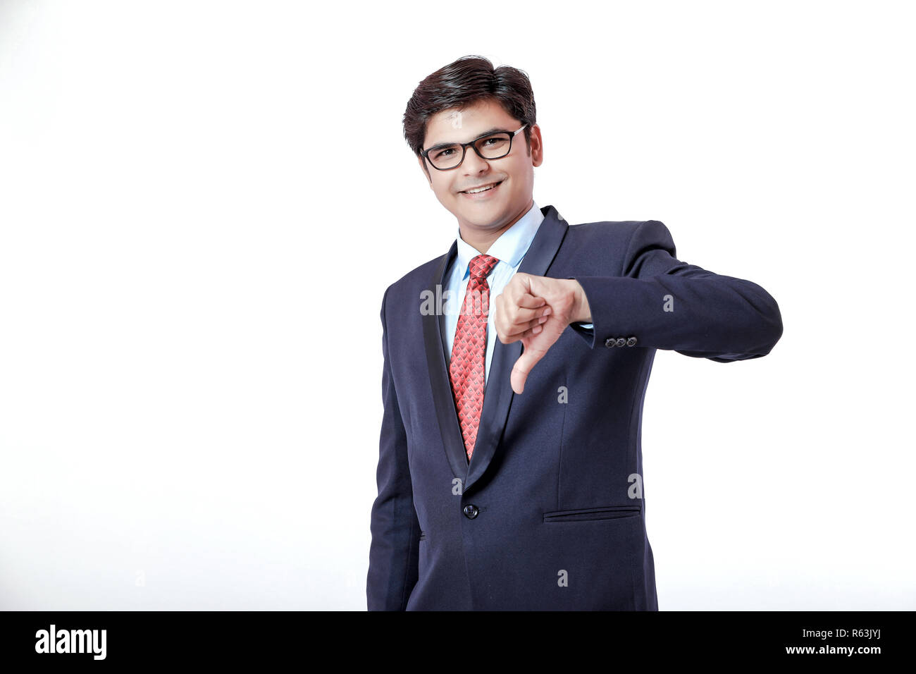 Young Indian businessman showing thumb down Stock Photo