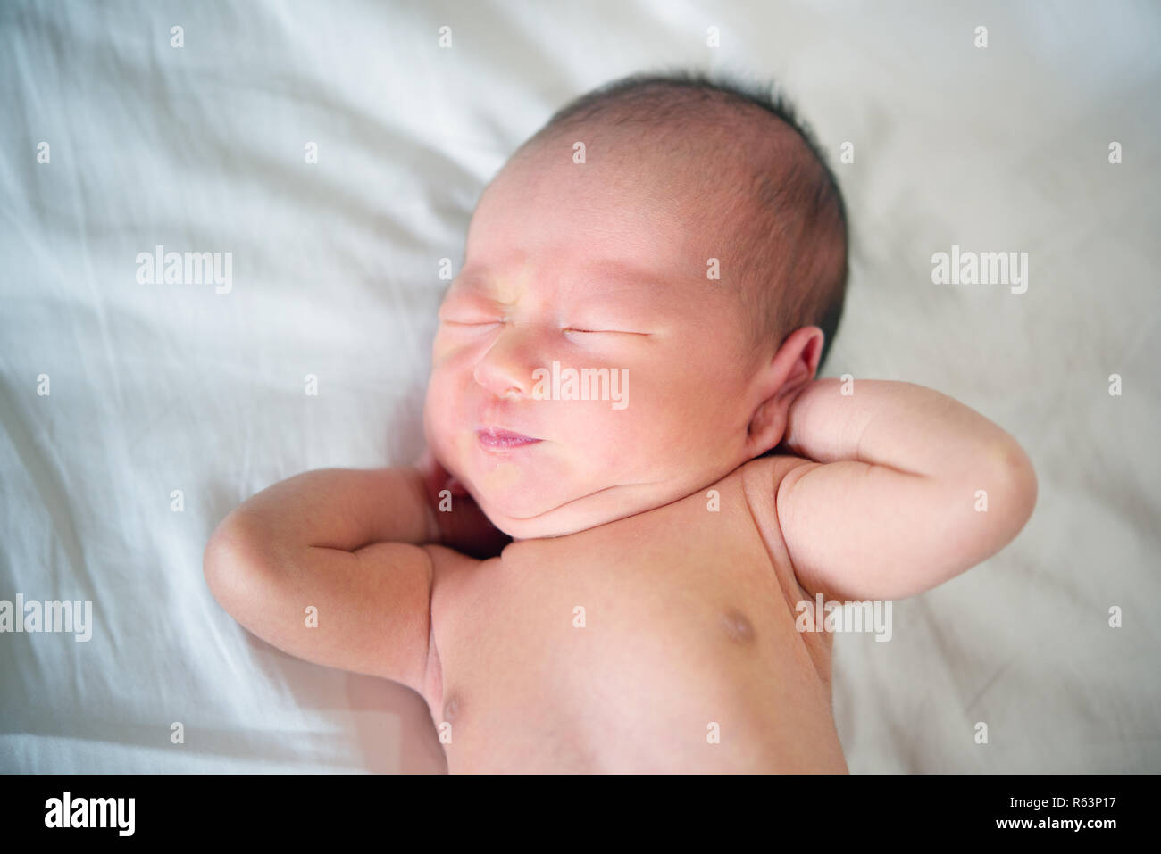 Newborn baby wakes up and stretches Stock Photo Alamy