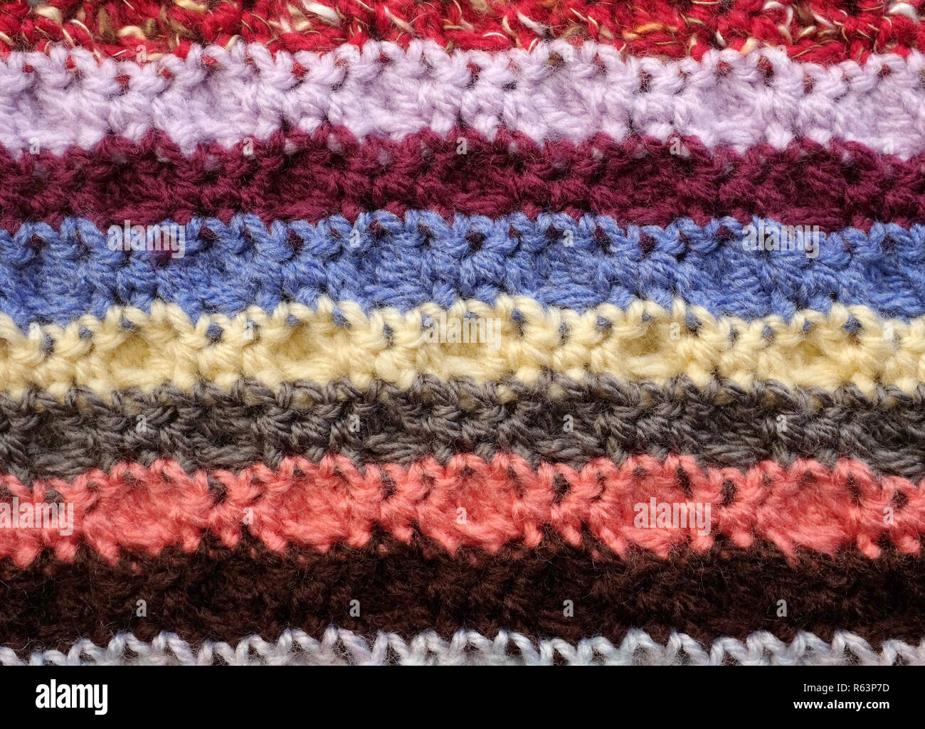 Horizontal stripes of coloured crochet stitches background Stock Photo