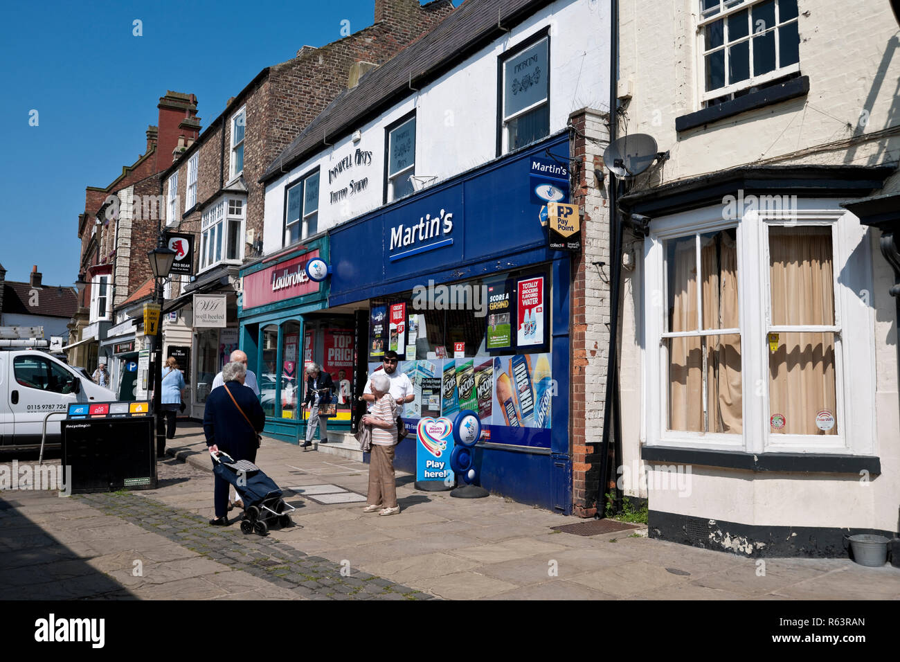 Martins supermarket and Ladbrokes betting shop store in the town centre Market Place Thirsk North Yorkshire England UK United Kingdom GB Great Britain Stock Photo