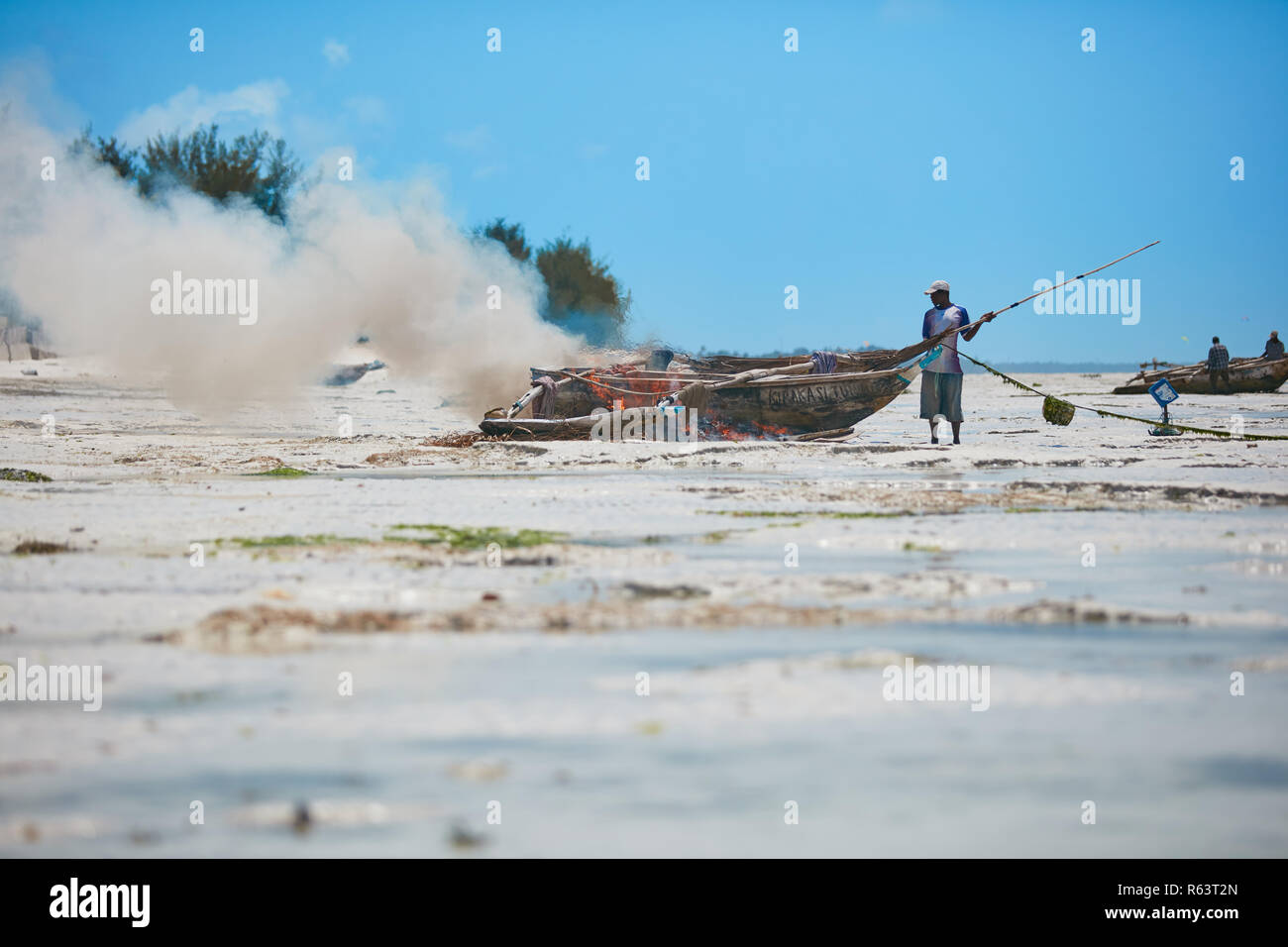 African fisherman are burning his boat Stock Photo