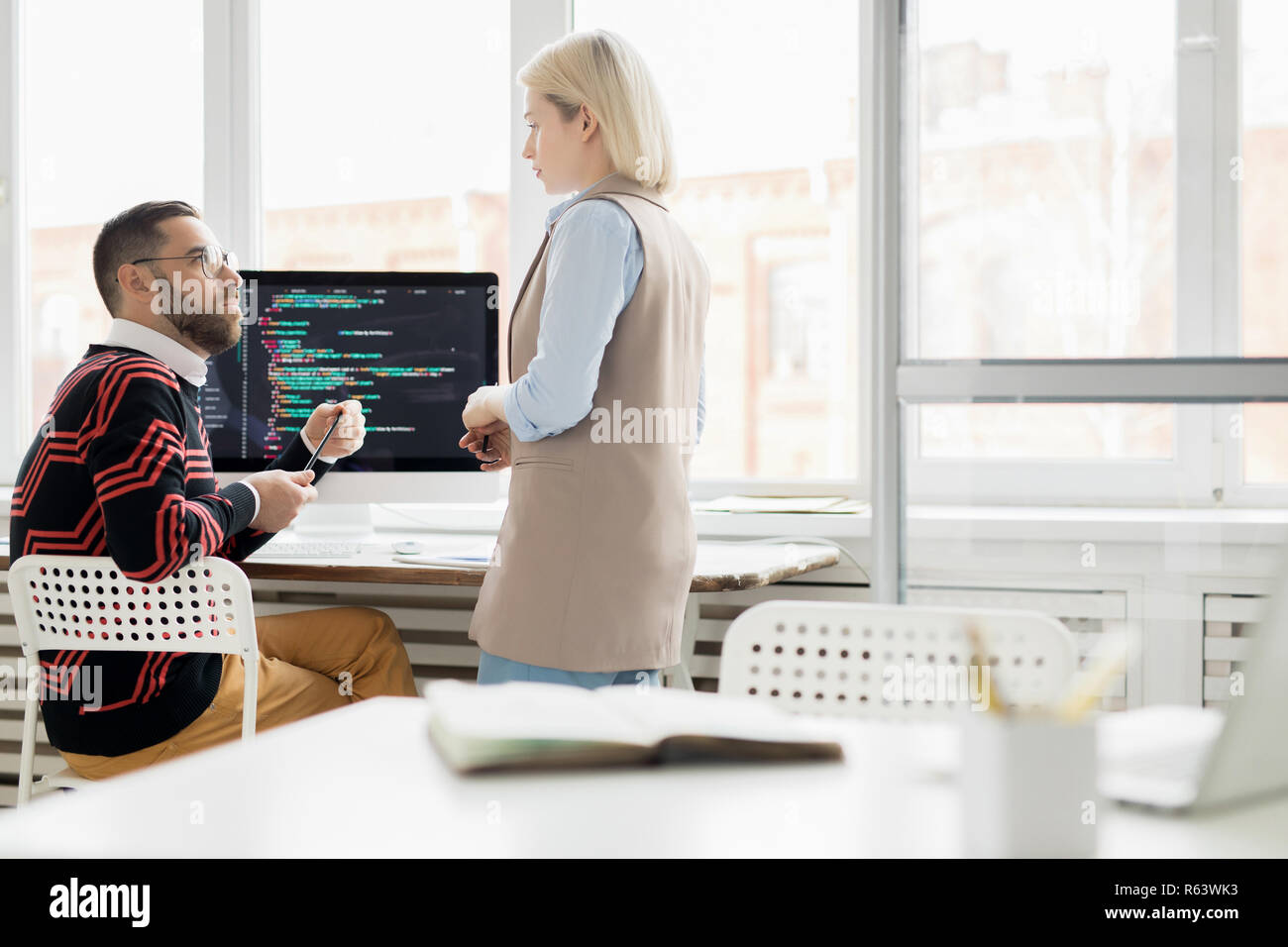 Young lady working with programmer in office Stock Photo