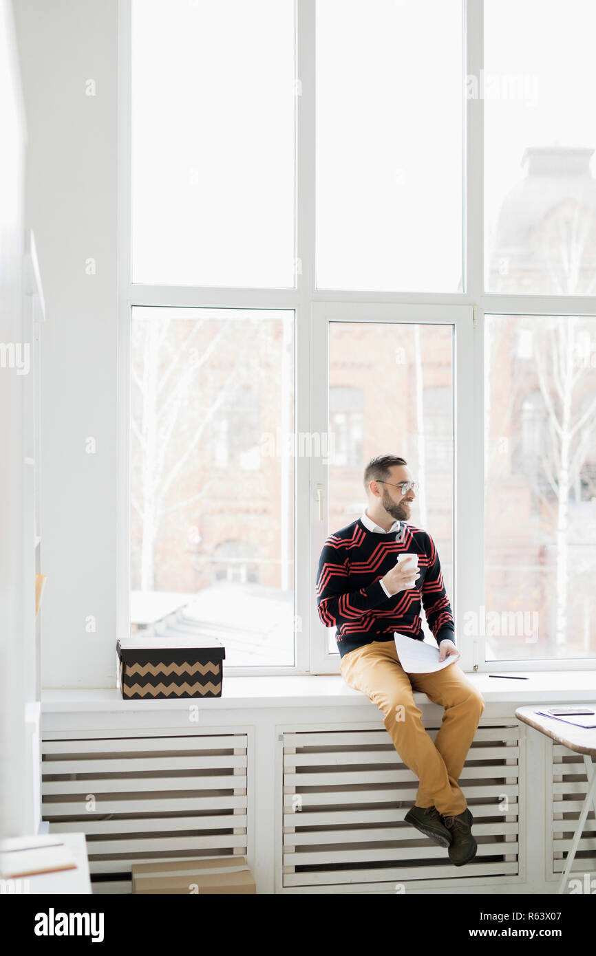 Happy relaxed hipster manager in office Stock Photo
