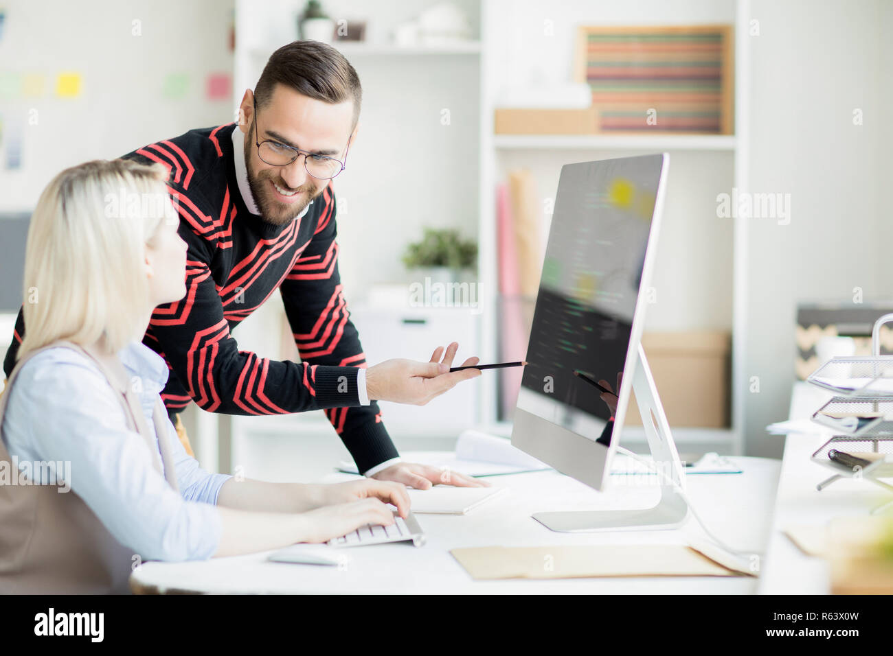 Cheerful colleagues discussing app development Stock Photo