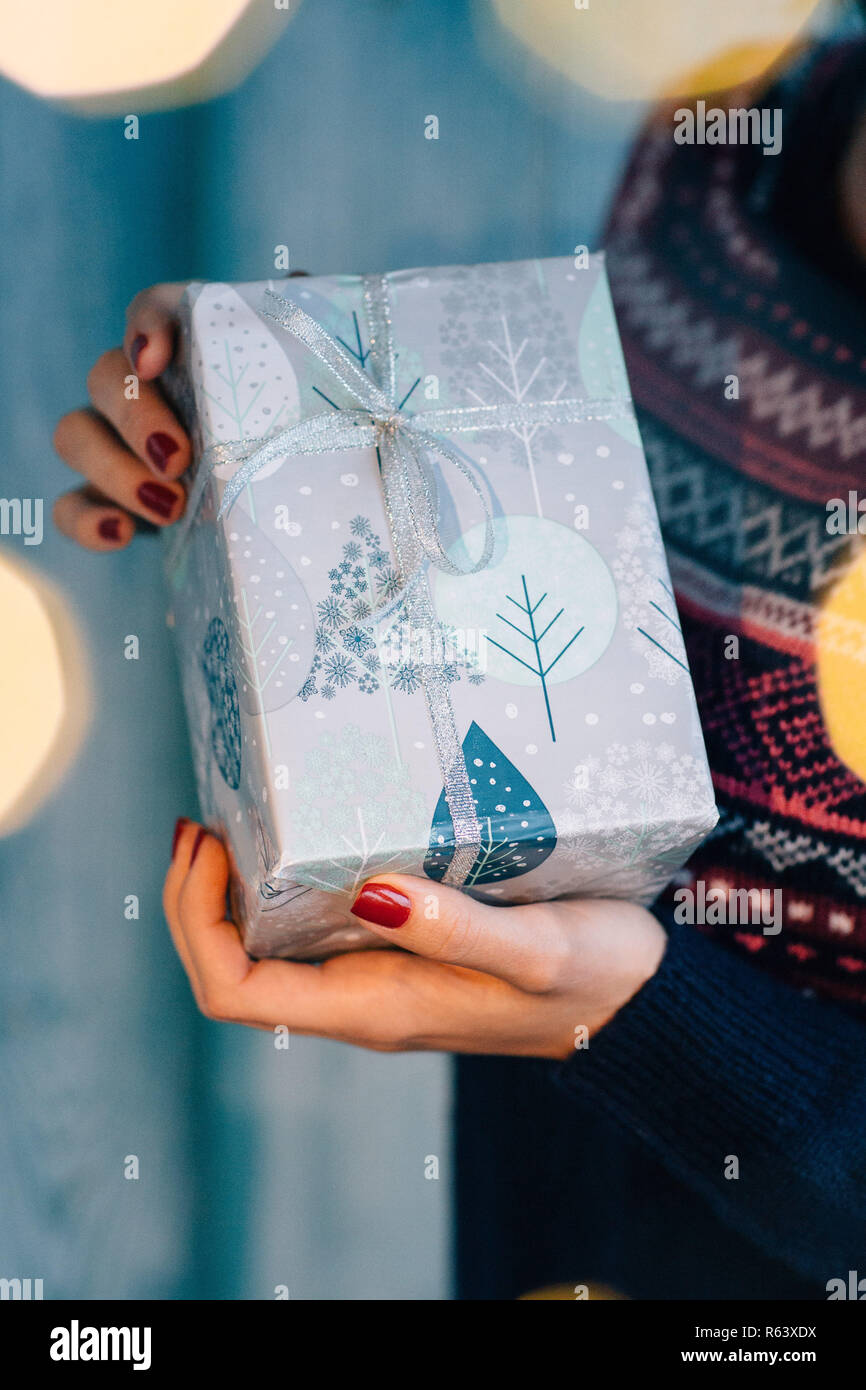 Girl holding a Christmas present Stock Photo - Alamy