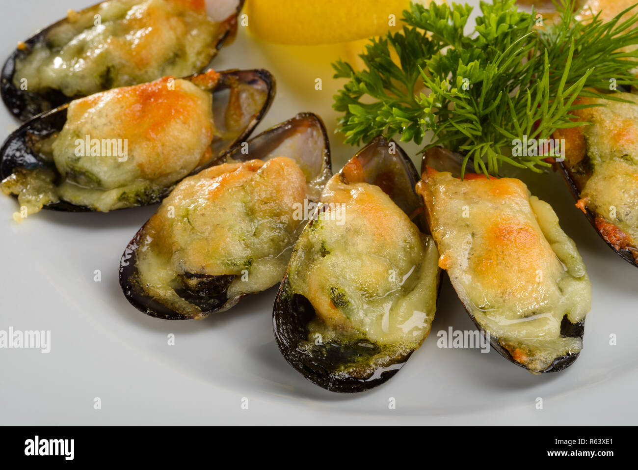 Baked mussels with green butter Stock Photo Alamy
