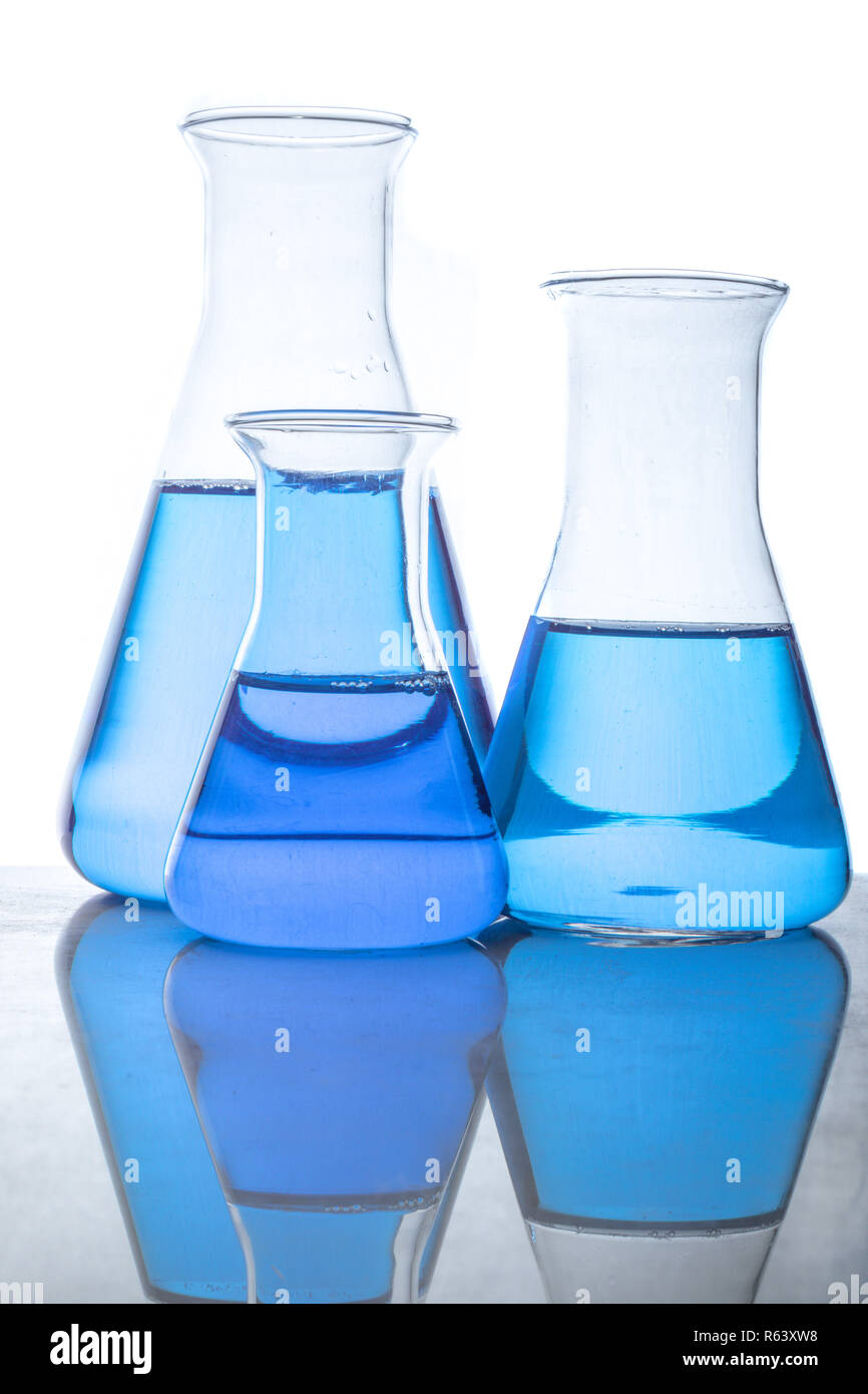 Glass flasks with blue fluid in used in chemistry experiments Stock