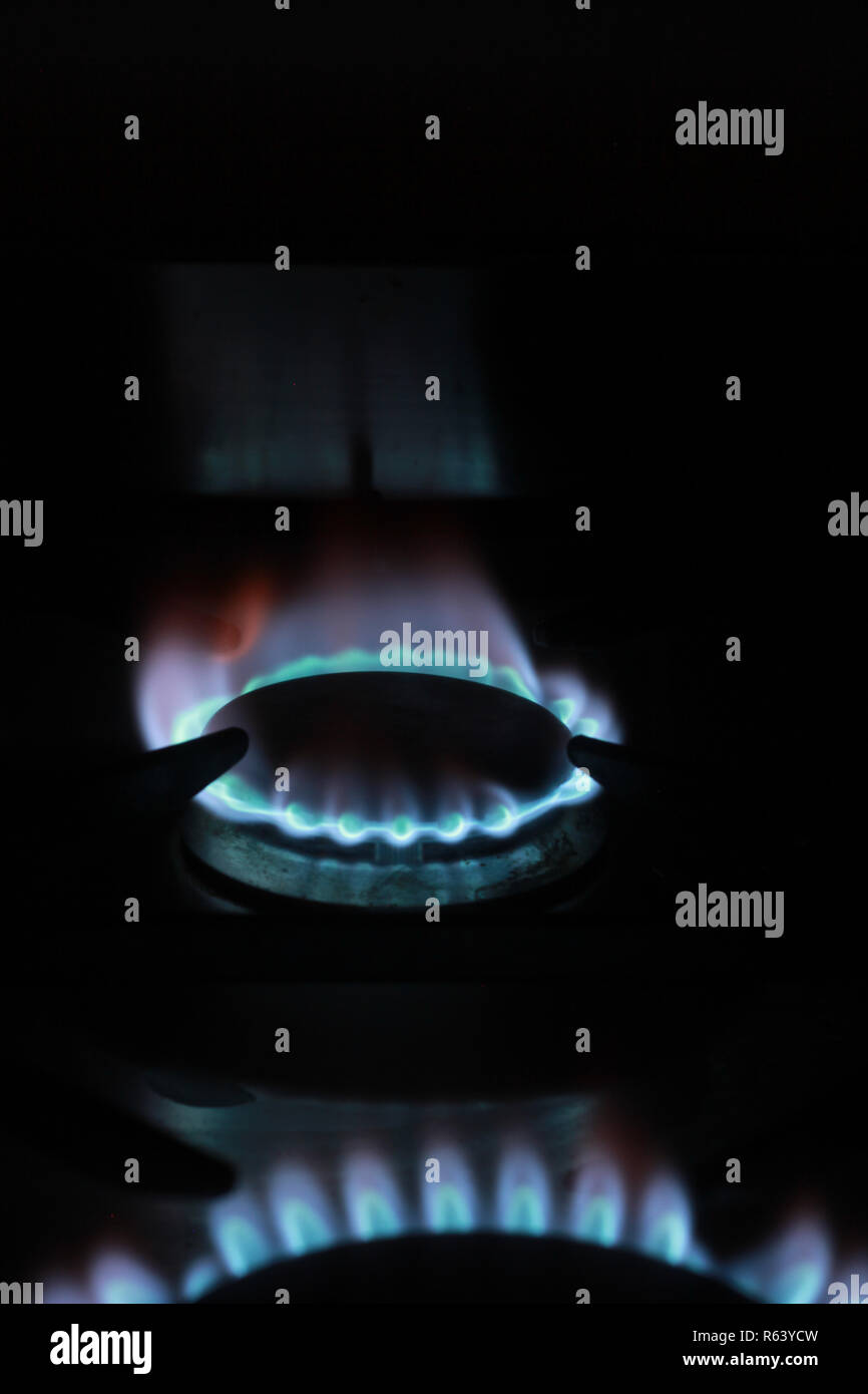 Blue flames on a gas hob Stock Photo