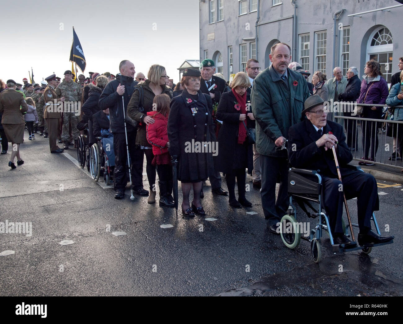 Old soldiers and civilians gather in the village of Rottingdean on Remembrance day Stock Photo