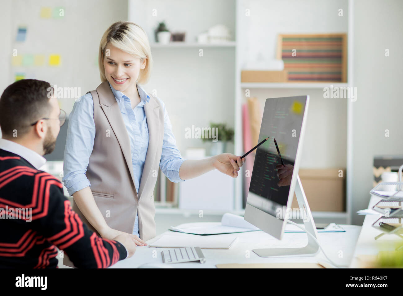 Confident pretty web designer presenting her project Stock Photo
