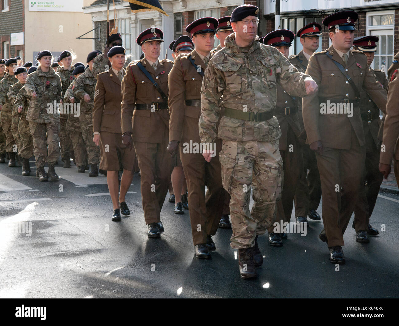 Soldiers marching through the village of Rottingdean on Remembrance Day Stock Photo