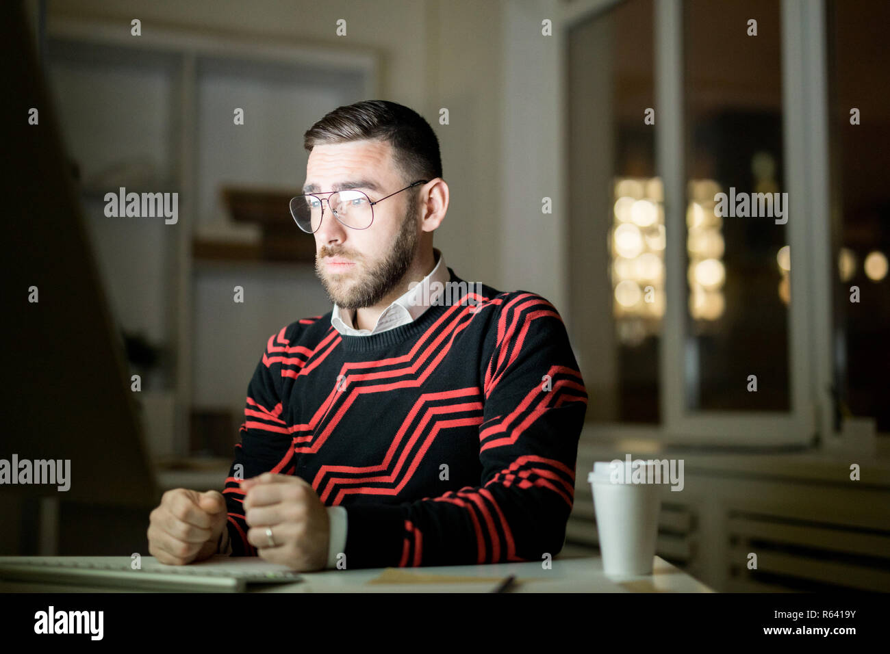 Exhausted manager trying to work at night Stock Photo