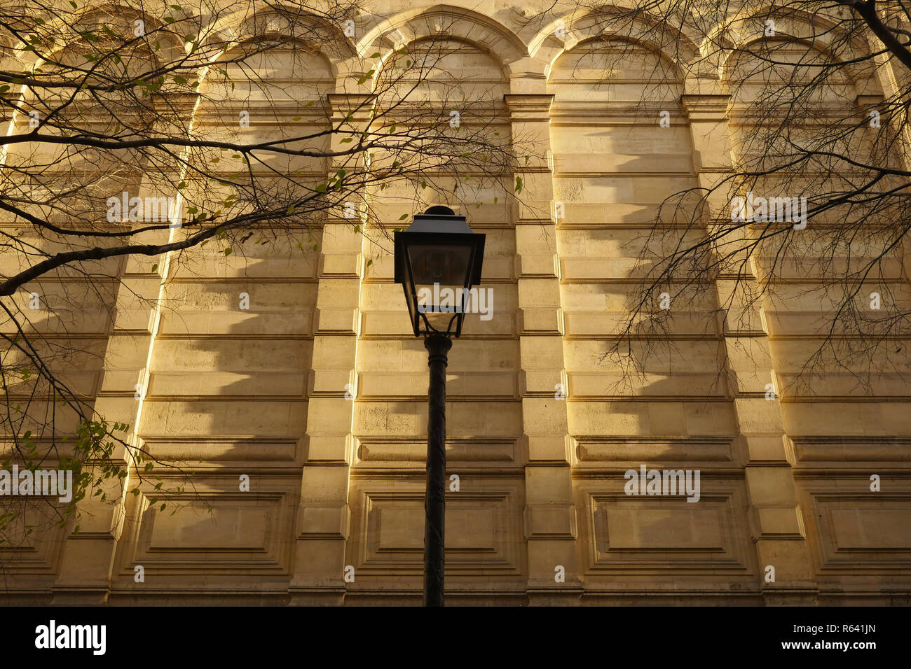 A Parisienne lamp against a stone wall of des Archives in the Marais Paris. Stock Photo