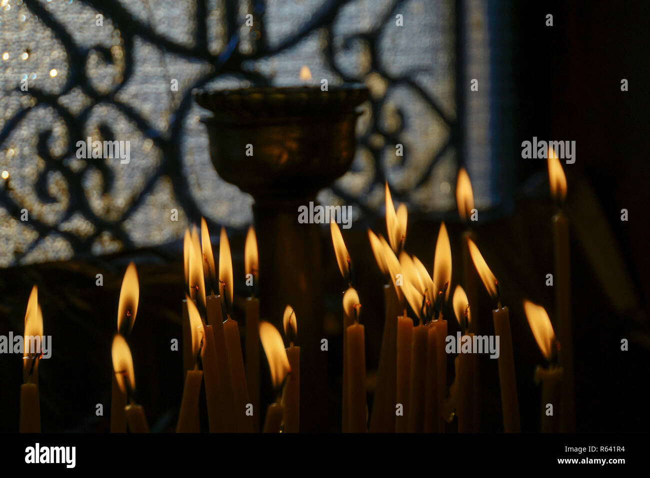 Lit candles in the interior of Agios Georgios (St. George) chapel at the top of the Lycavittos hill in Athens, Greece Stock Photo