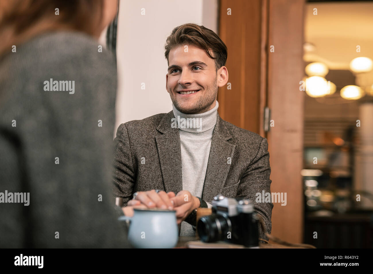 Smiling man talking with the woman in the cafe Stock Photo