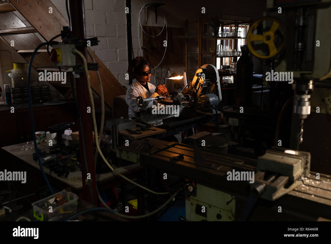 Worker using welding torch in glass factory Stock Photo