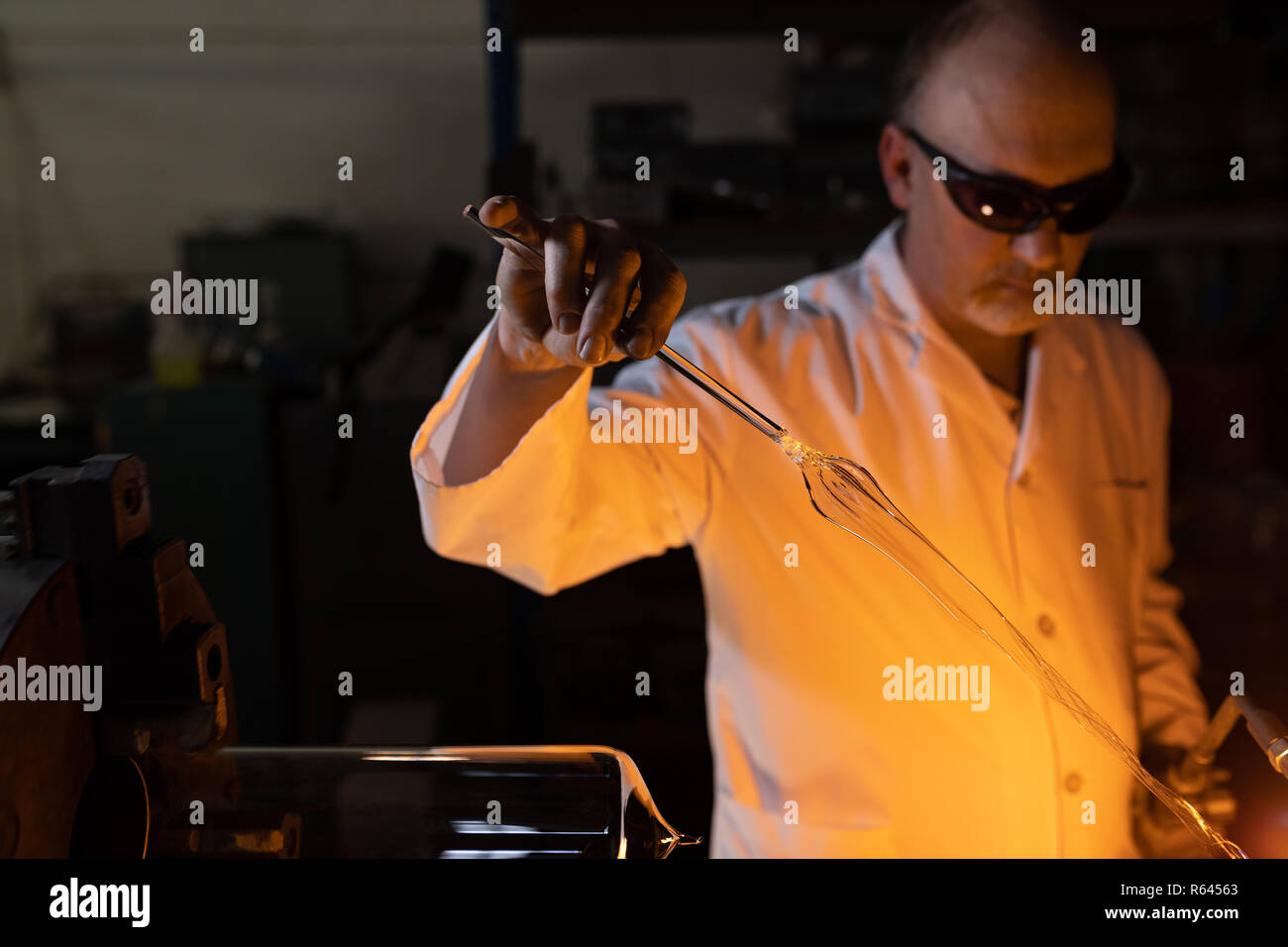 Worker using welding torch in glass factory Stock Photo