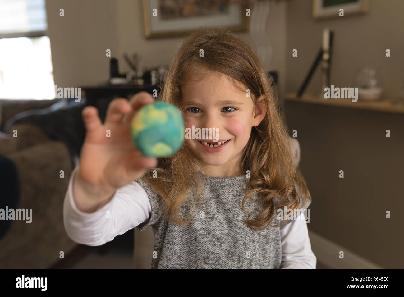 Girl playing with toy at home Stock Photo - Alamy