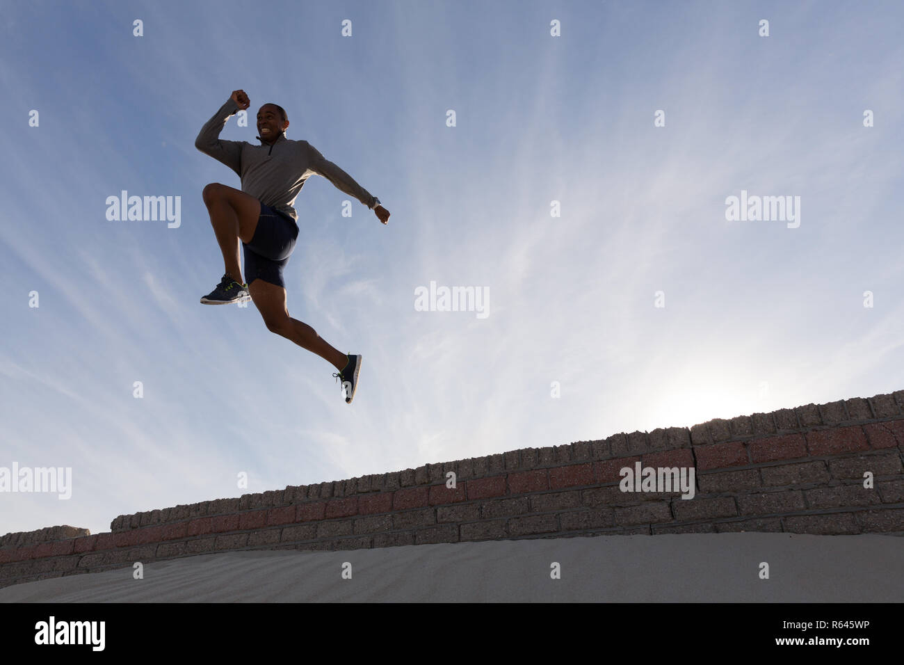 Male athlete jumping from surrounding wall Stock Photo