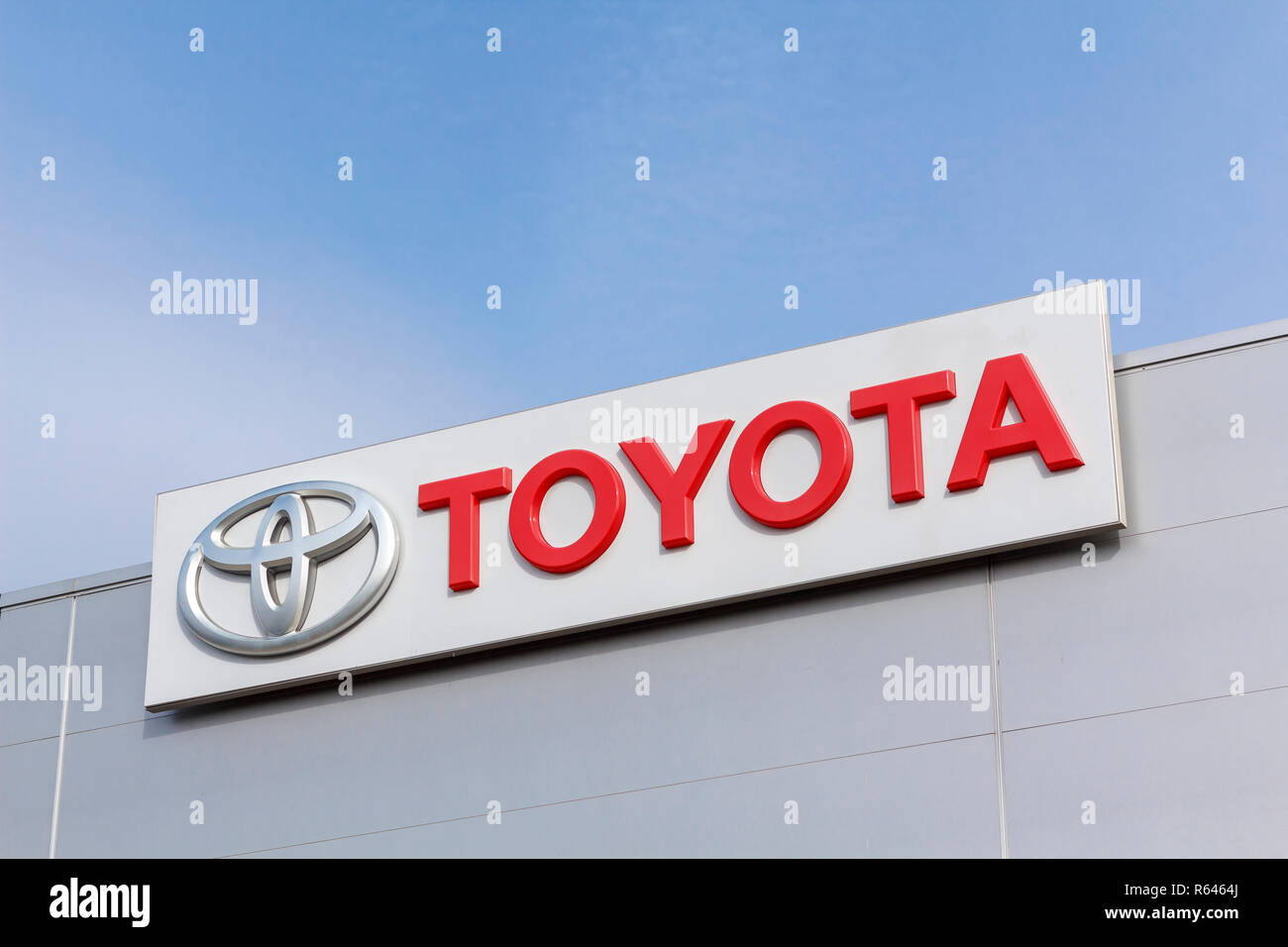 Toyota logo in a dealership building. Toyota is the world's leader in hybrid electric cars Stock Photo