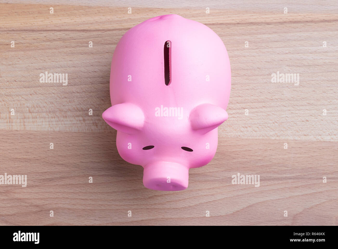 Piggy bank on wooden table Top view Stock Photo