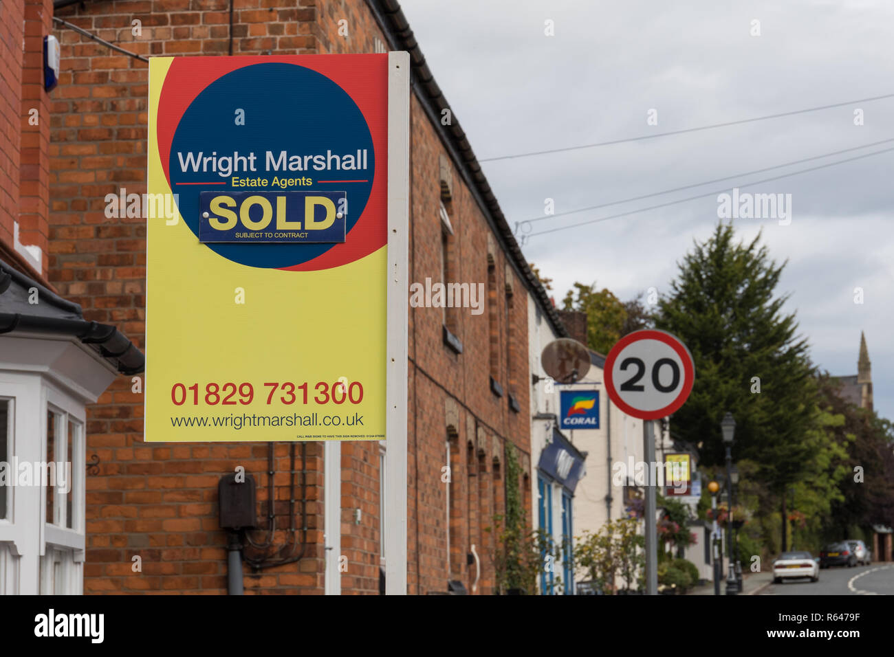 Sold sign outside house property in England - Tarporley, Cheshire, UK Stock Photo