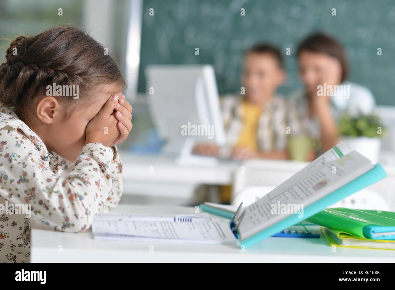 Portrait of cute little girl sitting in classroom Stock Photo - Alamy