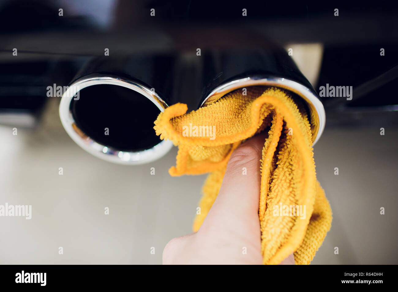 Chrome exhaust pipe of red powerful sport car bumper. car silencer