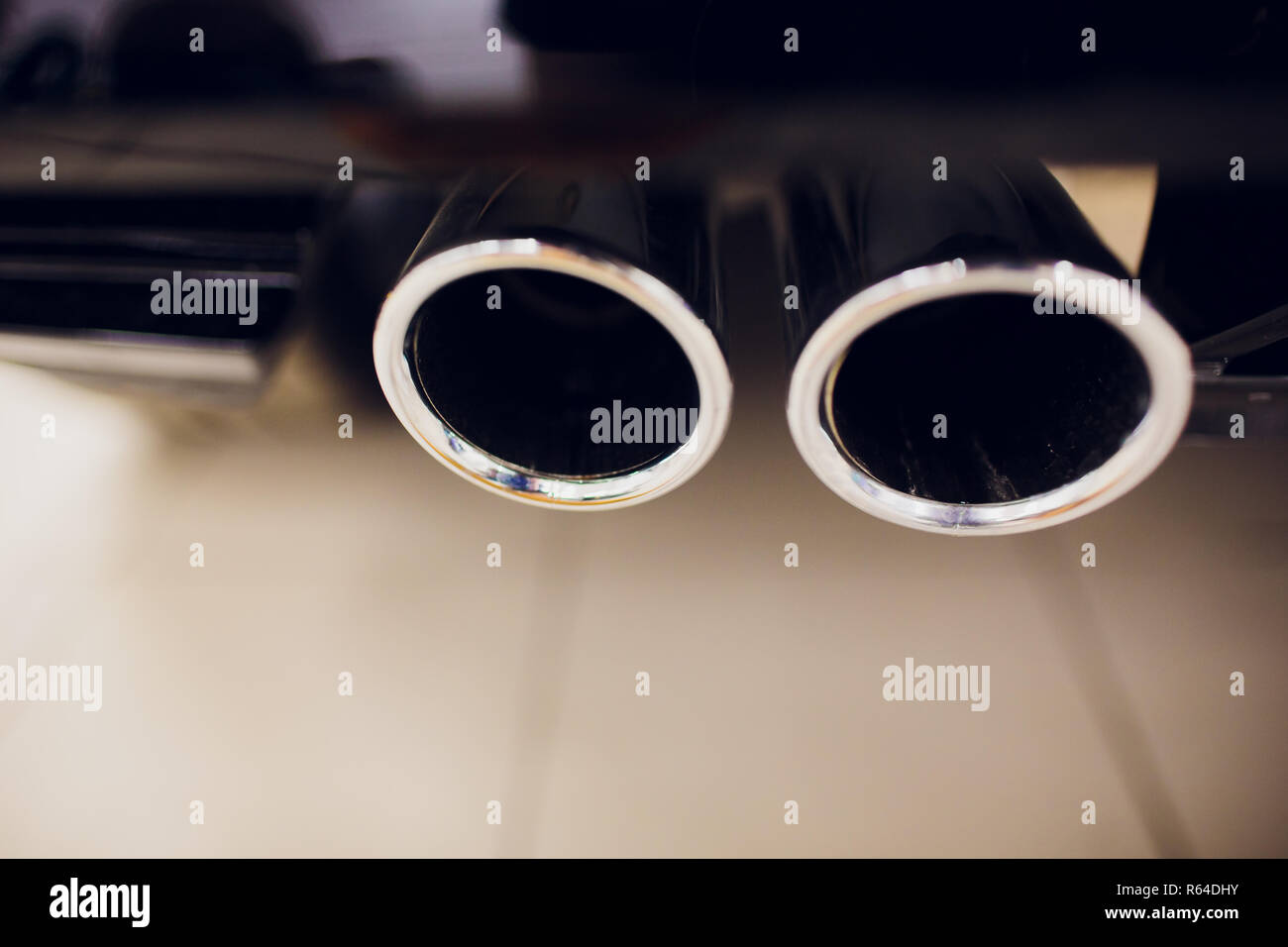 Chrome exhaust pipe of red powerful sport car bumper. car silencer