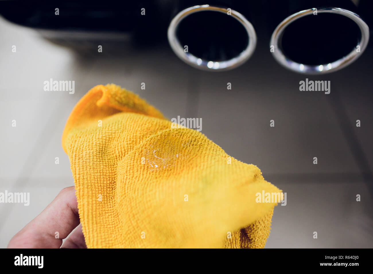 Chrome exhaust pipe of red powerful sport car bumper. car silencer