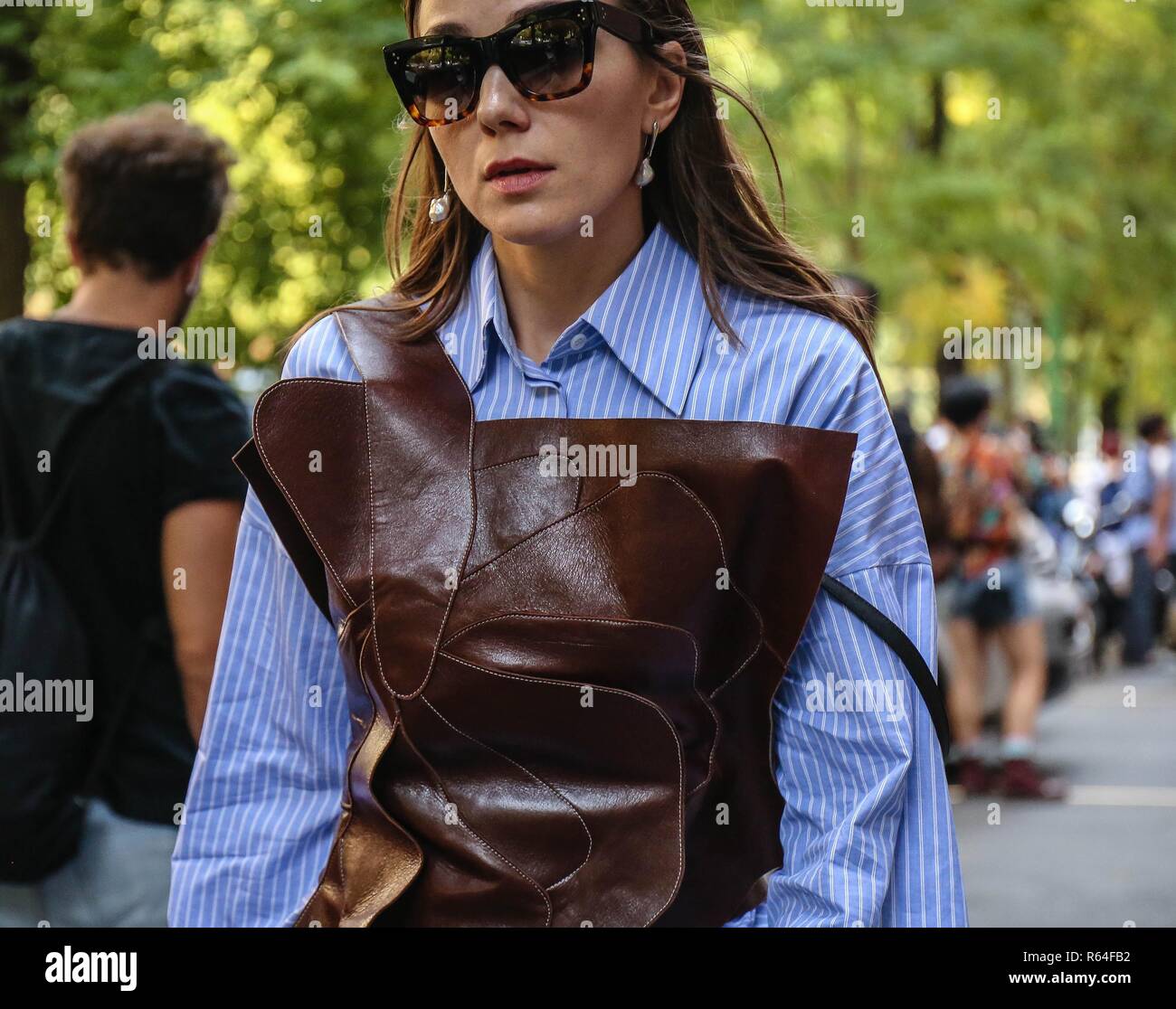 MILAN, ITALY - SEPTEMBER 20, 2018: Woman with small Louis Vuitton