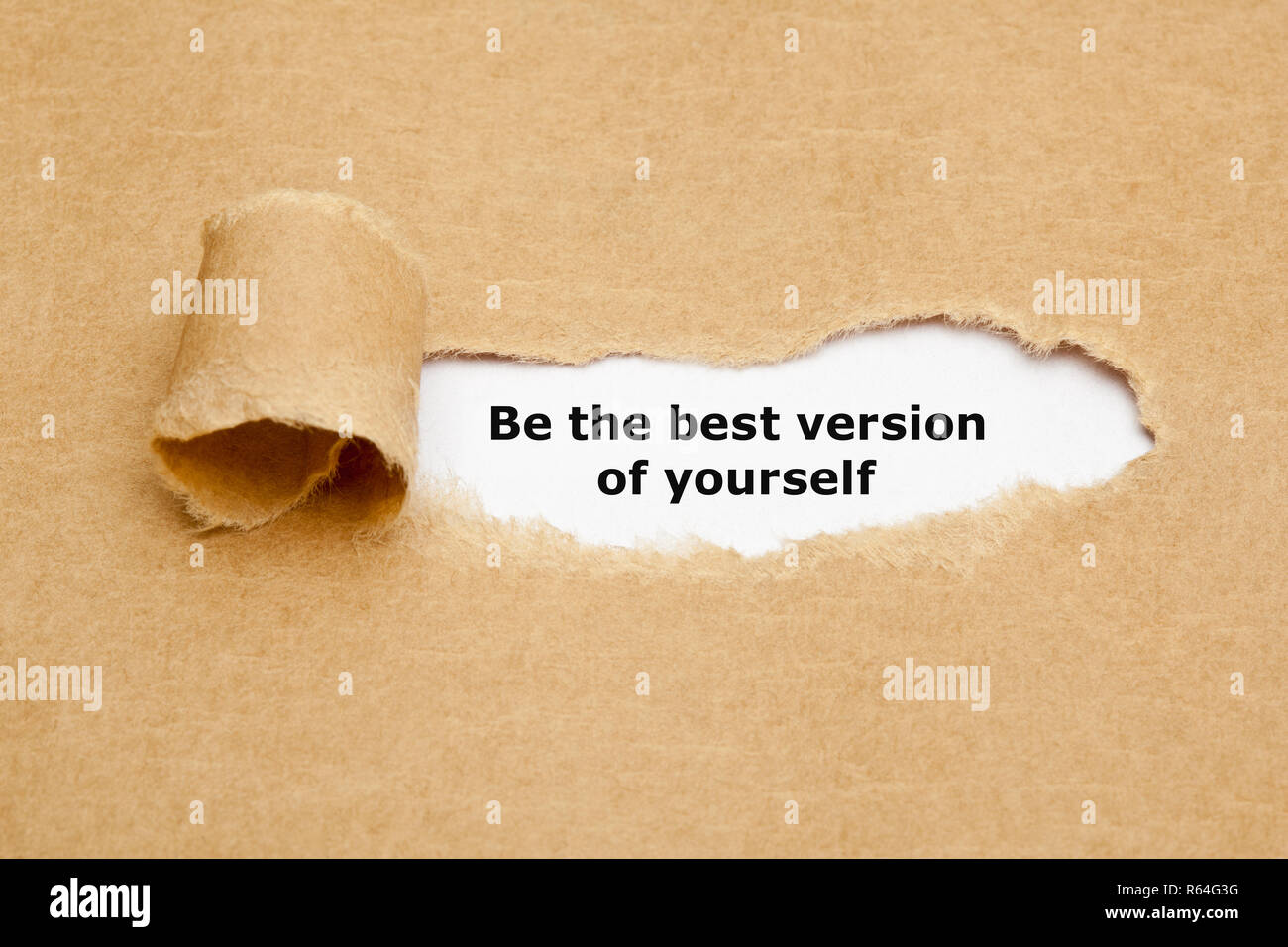Motivational quote Be The Best Version Of Yourself appearing behind torn brown paper. Stock Photo