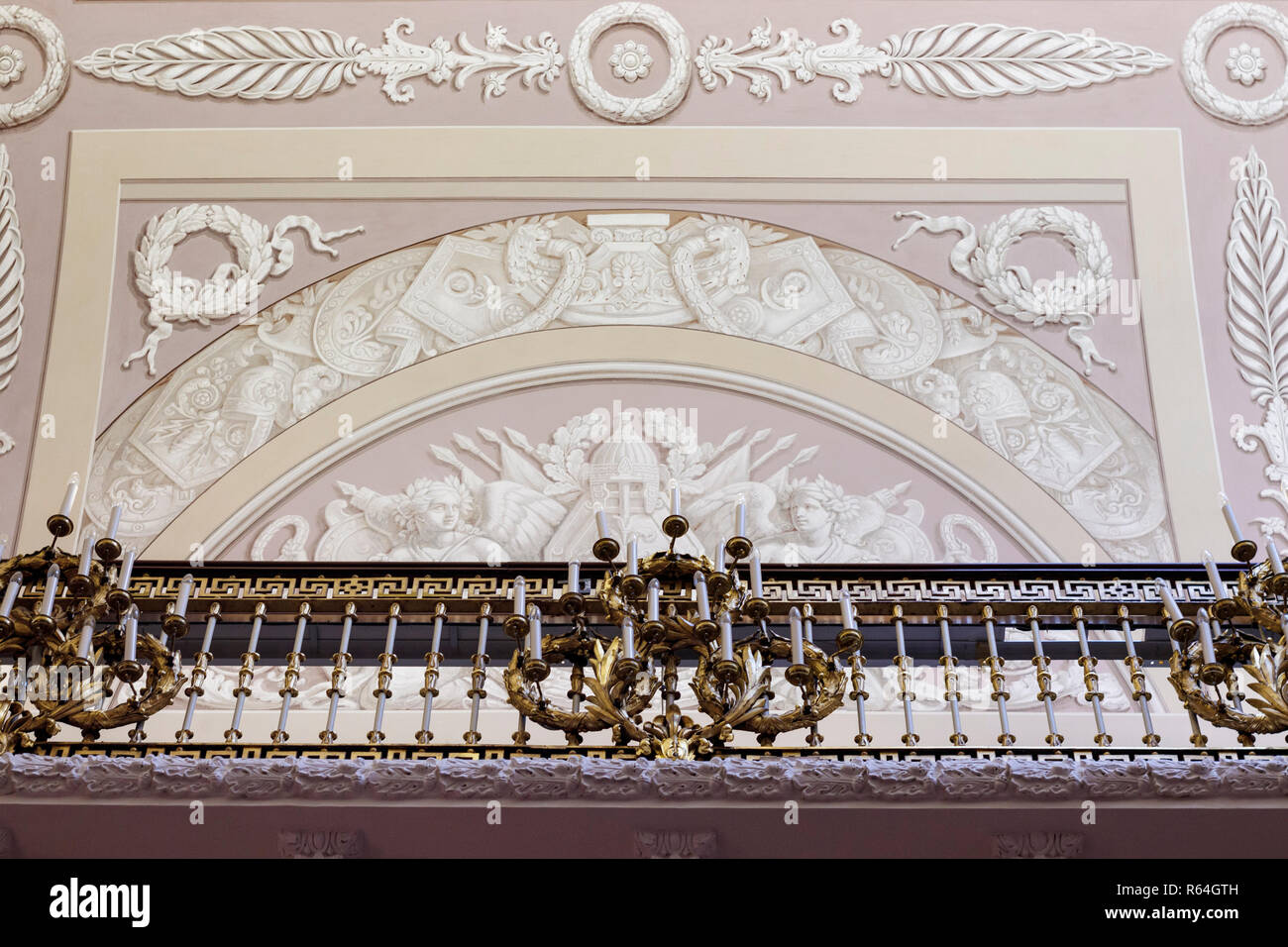 Gallery rail and wall showing intricate and ornate design with electrical candle light sconces. The Hermitage Museum, Winter Palace, St Petersburg. Stock Photo