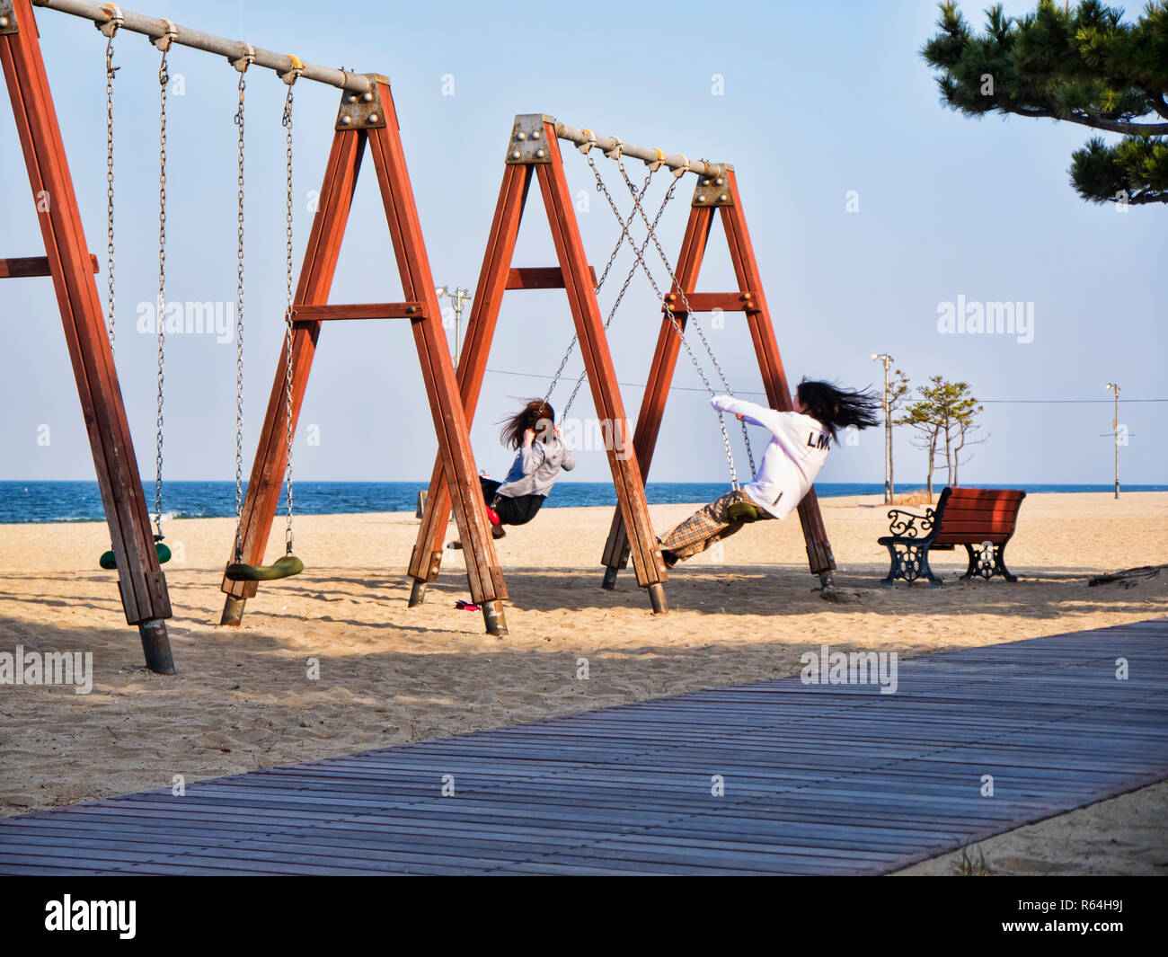 Girls on swings hires stock photography and images Alamy
