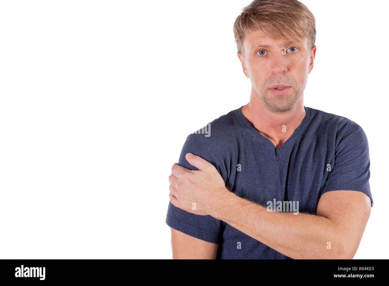Man holding his sore shoulder trying to relieve pain Stock Photo Alamy
