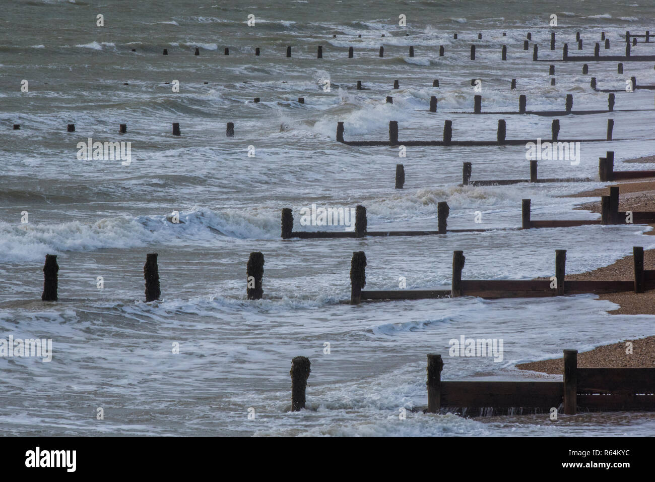 wooden groynes and breakwaters on the seafront in rough weather at Bognor regis in west sussex. Stock Photo