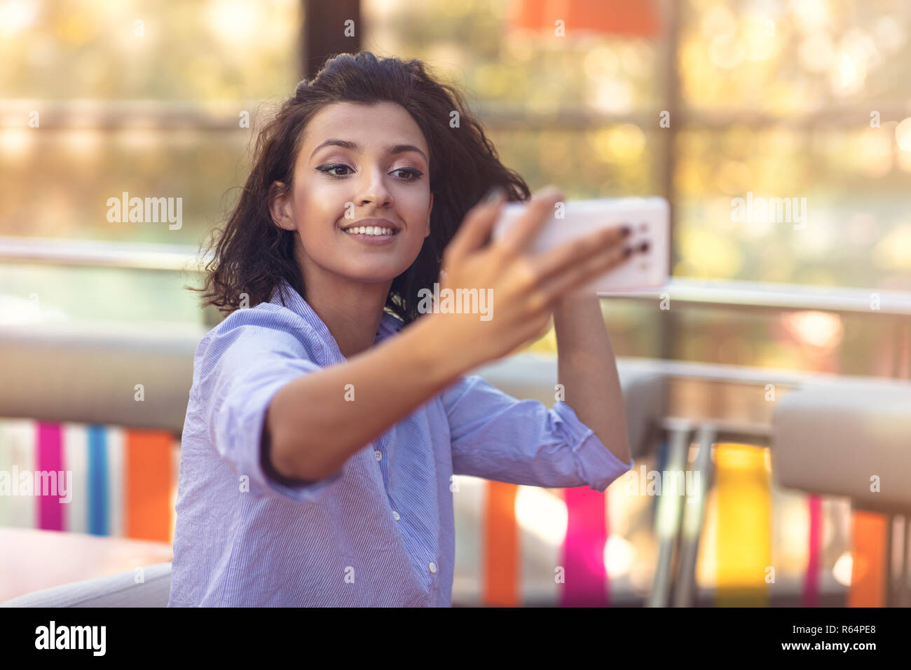 Young woman taking a selfie in coffee shop Stock Photo - Alamy