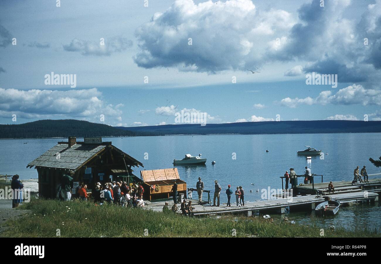 Scene on the shores of the Pineview Reservoir, in Ogden Valley, Utah, June, 1958. At left foreground is a boat rental shack surrounded by a crowd of visitors waiting on the dock. () Stock Photo