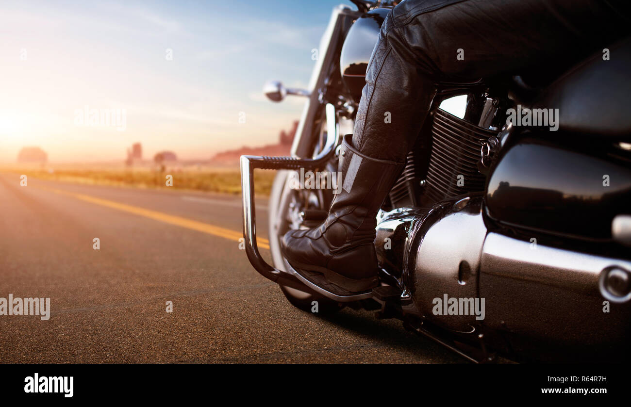 Rear view man riding motorcycle on the desert road hi-res stock ...