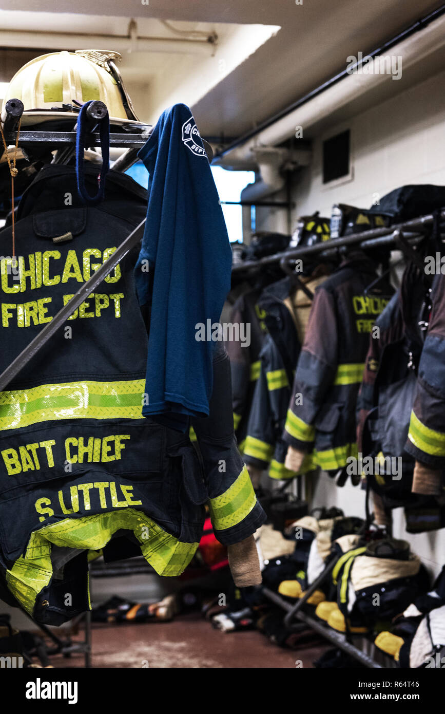 CHICAGO, ILLINOIS, USA - OCTOBER 10, 2018: The fireman's clothes by the real squad fire truck in Chicago Fire Department at the quarters of Engine Co. Stock Photo