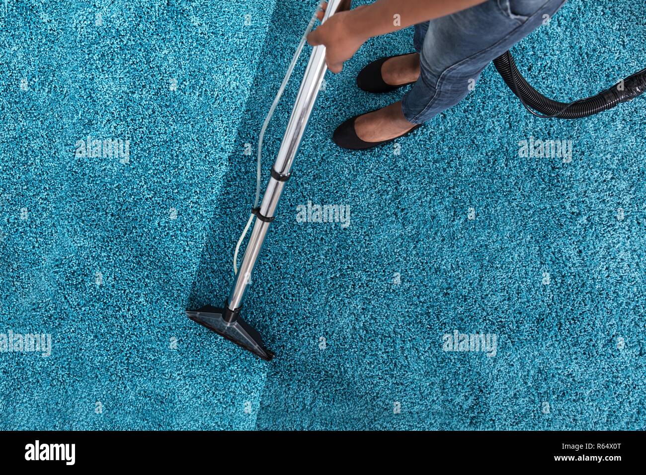 Person Using Vacuum Cleaner For Cleaning Carpet Stock Photo Alamy