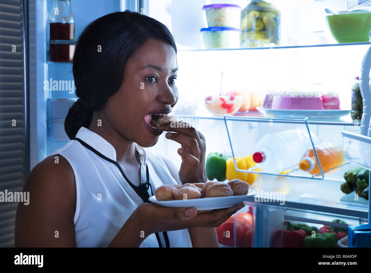 Close-up Of A Woman Eating Cookie Stock Photo