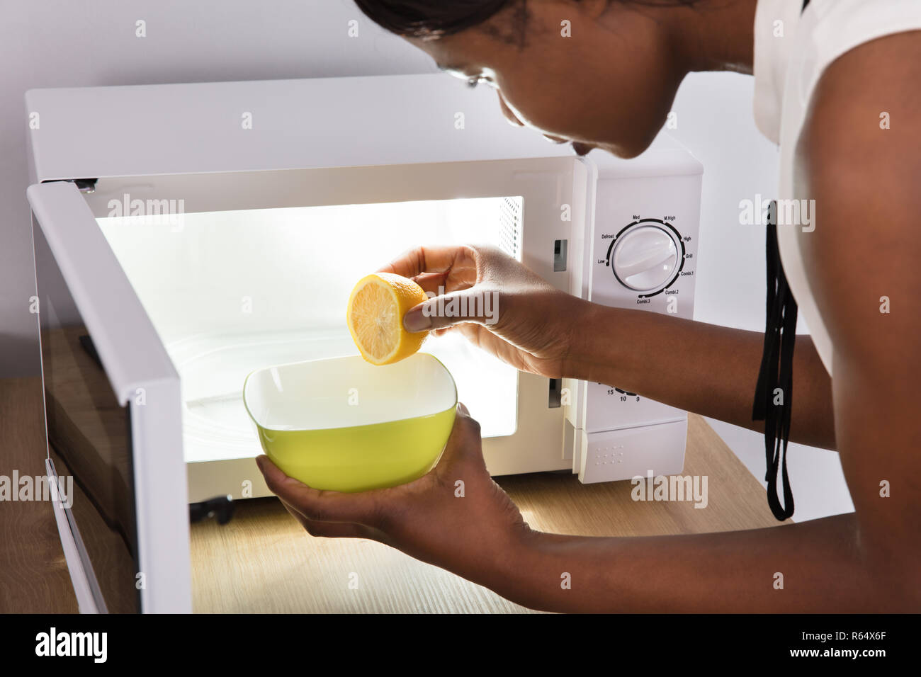Human Hand Putting Sliced Lemon In Bowl Stock Photo Alamy