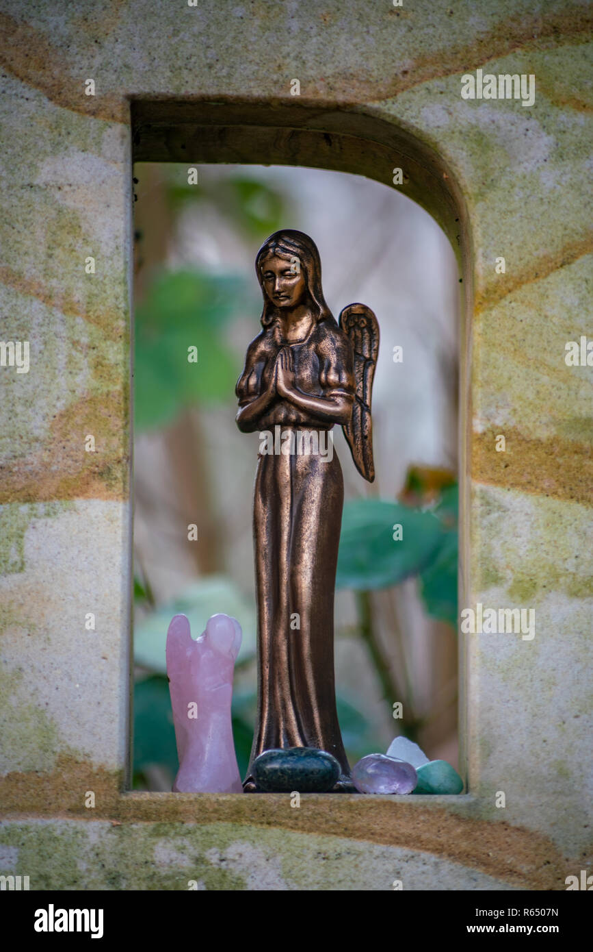 Figure Of A Praying Little Angel As Part Of A Tombstone On A Grave