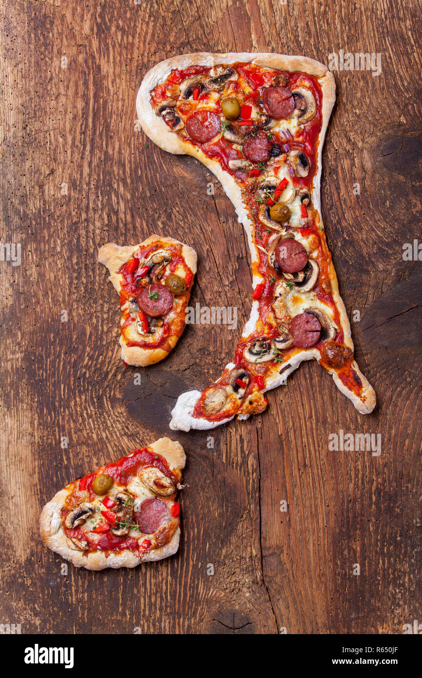 pizza in the shape of thn italian peninsula Stock Photo