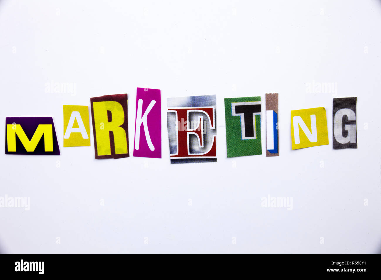 A word writing text showing concept of Marketing made of different magazine newspaper letter for Business case on the white background with copy space Stock Photo