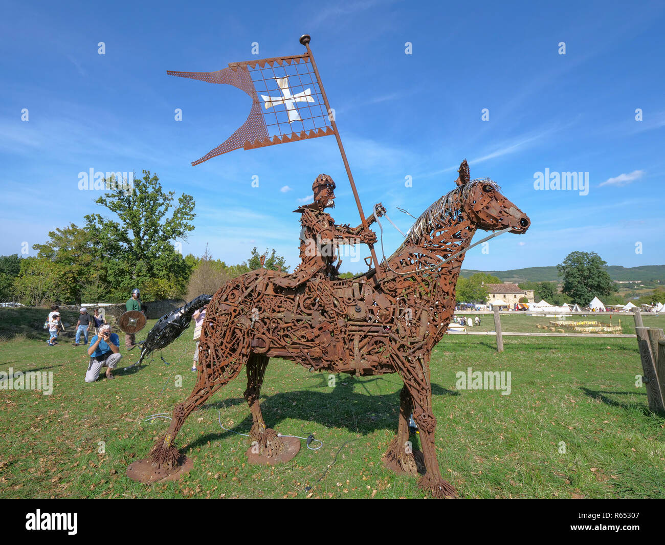 Knight carrying Crusader flag, all made from scrap metal and nuts and bolts, at Medieval fair at Chateau de Lagarde, near Mirepoix, southern France Stock Photo