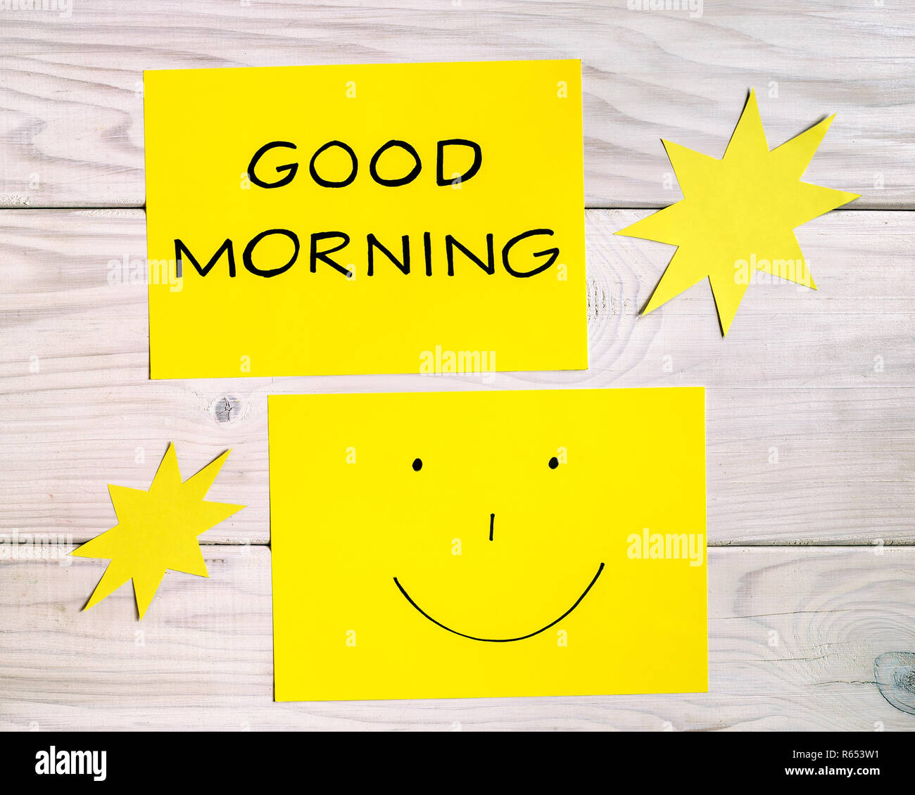 Text good morning and smiley face with sun shapes on wooden table ...