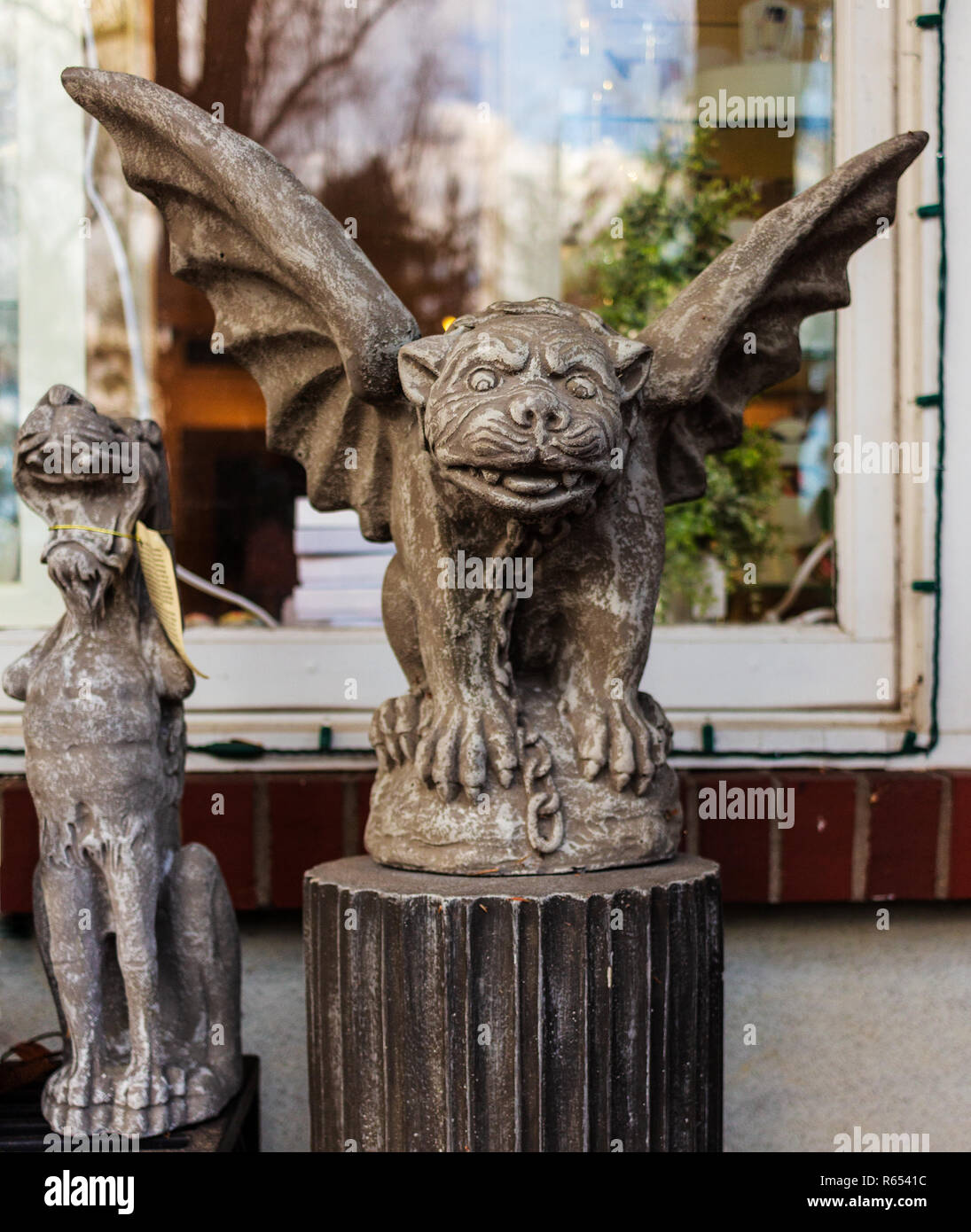 Two miniature gargoyle statues are for sale in front of the gift shop